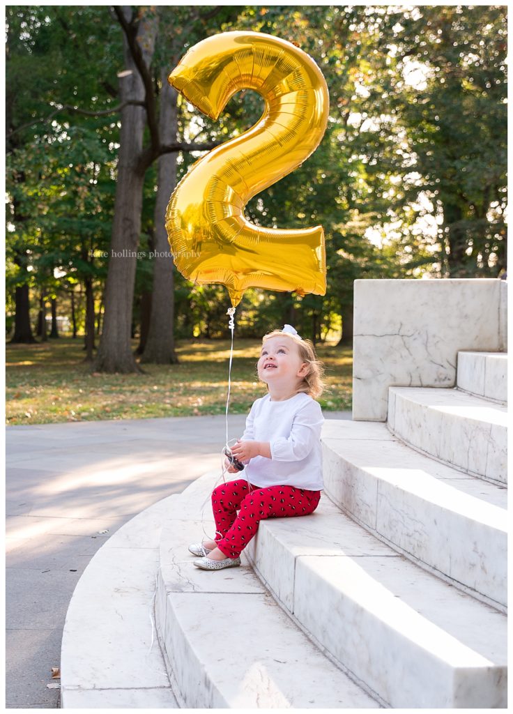 Toddler Holds Balloon for Birthday Photos